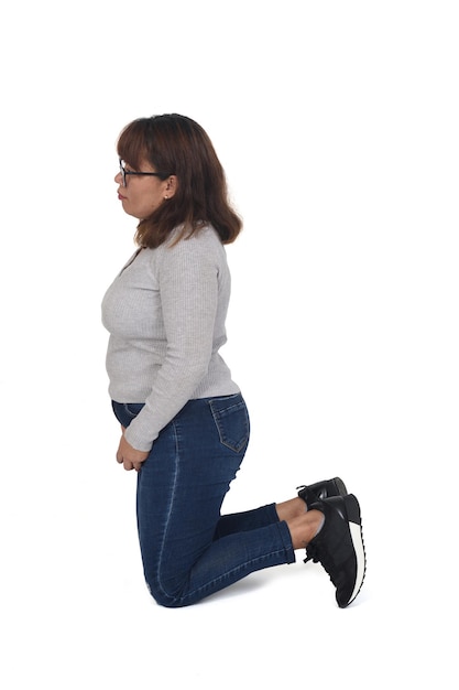 Side view of a woman kneeling on white background