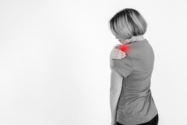 Side view woman massaging sore shoulder