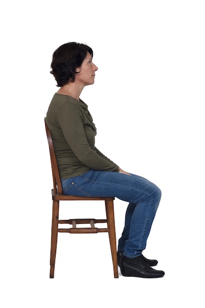 Side view of woman sitting on a chair on white background