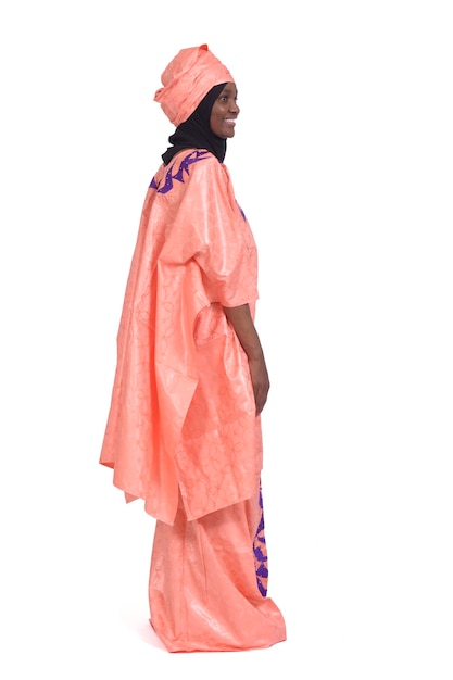 Side view of a woman with african traditional costume looking on white background