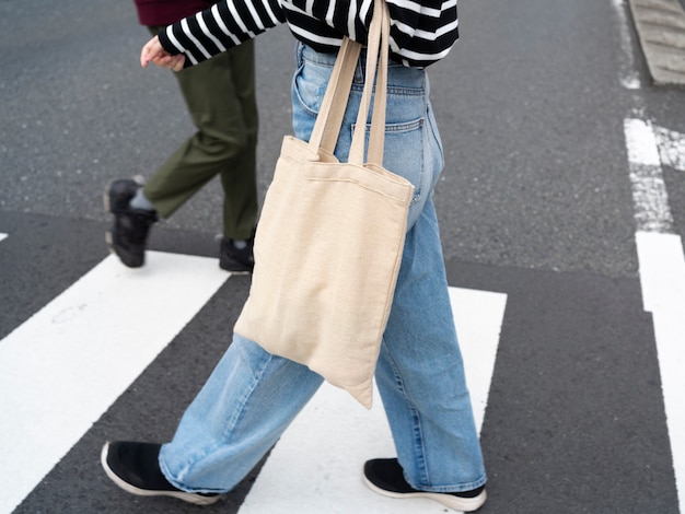 Side view woman with fabric bag