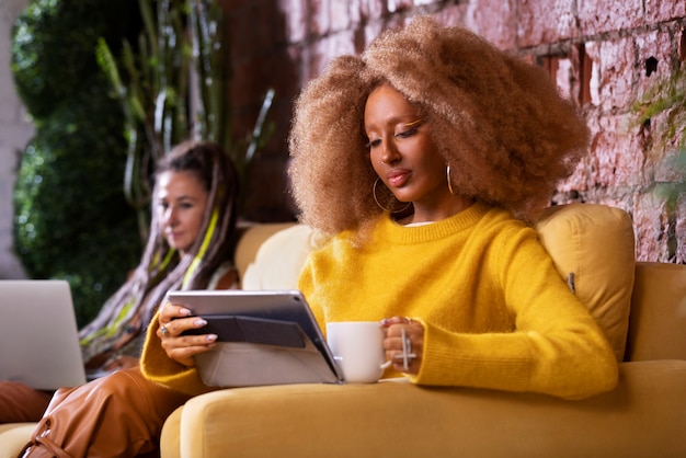 Side view women reading in cafe