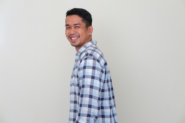 Side view of young Asian man smiling confident showing successful gesture