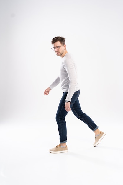 Side view of a young fashion man walking