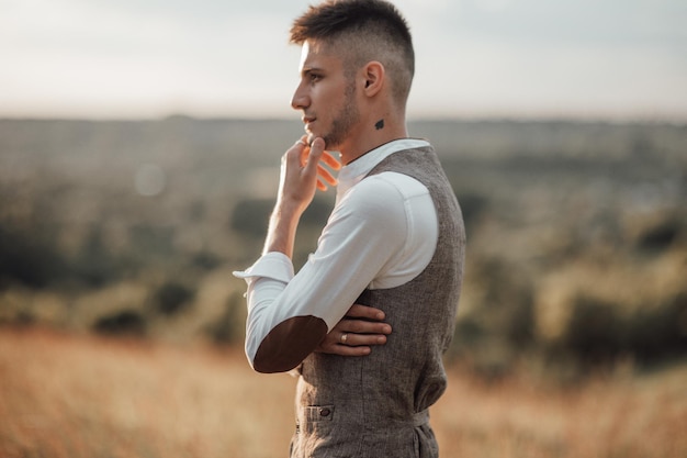 Photo side view of young man looking away outdoors