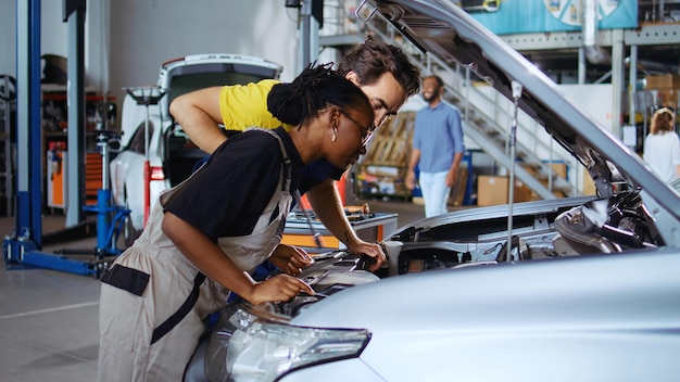 Side view of young man repairing car