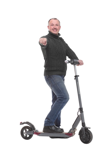 Side view of young modern man using and driving electric isolated over white background