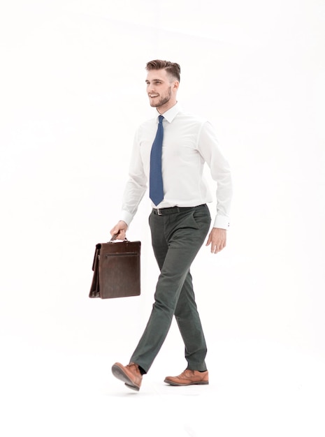 Side viewsmiling businessman confidently steps forward