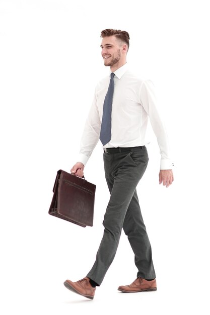 Side viewsmiling businessman confidently steps forwardisolated on white