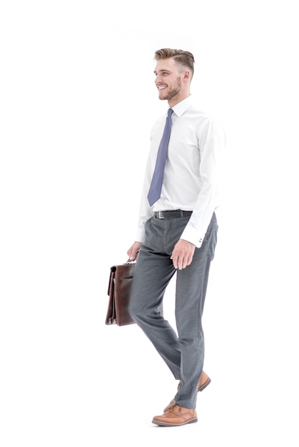 Side viewsmiling businessman confidently steps forwardisolated on white