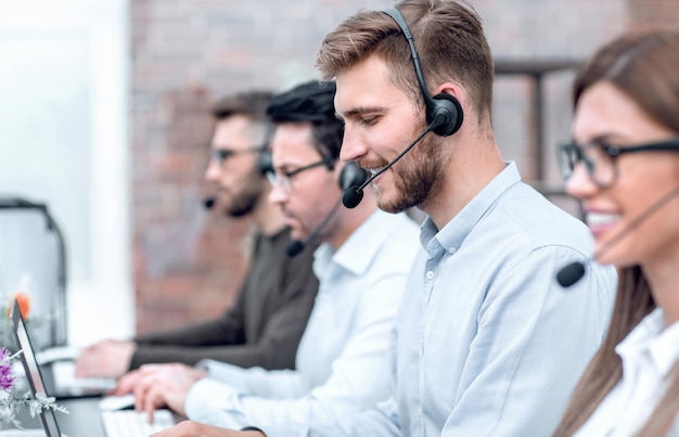 Side viewthe call center operator and her colleagues work in the office