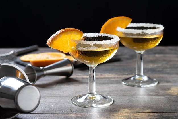 Sidecar cocktail with a sugar rim on wooden table