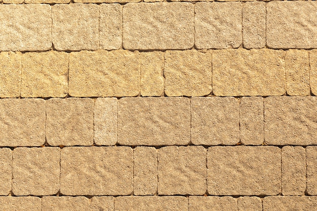 Sidewalk stone of various shapes in the sunset light masonry texture