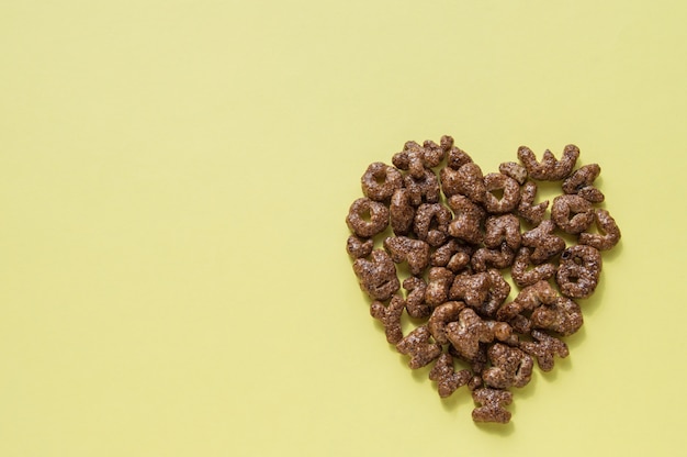 Sign of the heart of the dry Breakfast cereal in the form of letters, chocolate flakes useful food for children, top view