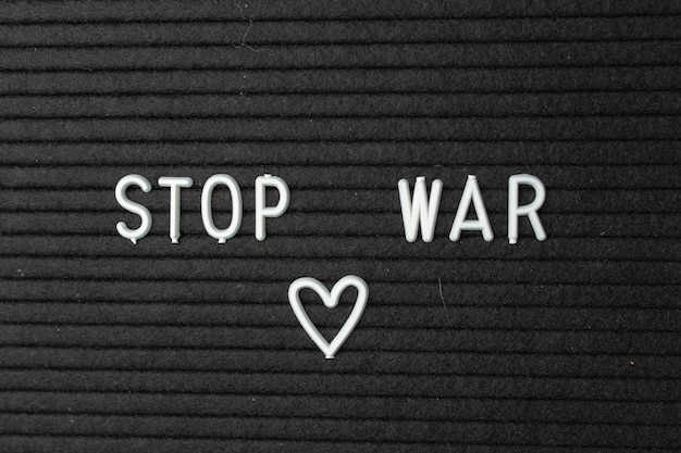 A sign with the inscription Stop the war on a blue background There is no war Stop the war Closeup