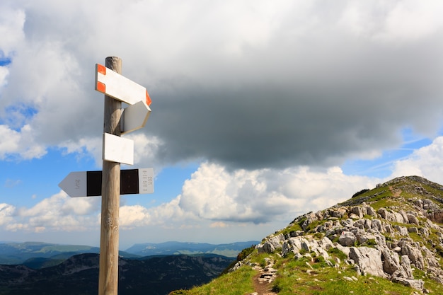 Signboard along a mountain trekking path, Italian panorama, Alps