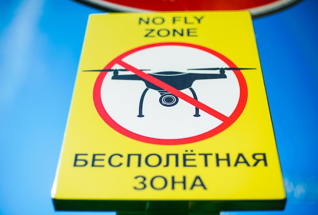 Signboard NO FLY ZONE with a picture of a dithered droning