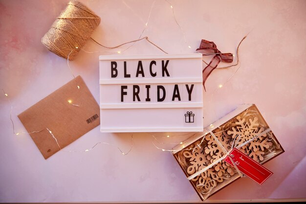 Signboard with text Black Friday and decorations Online shopping concept Buying presents for Christmas Safe home shopping Cozy home Christmas preparationsTop view