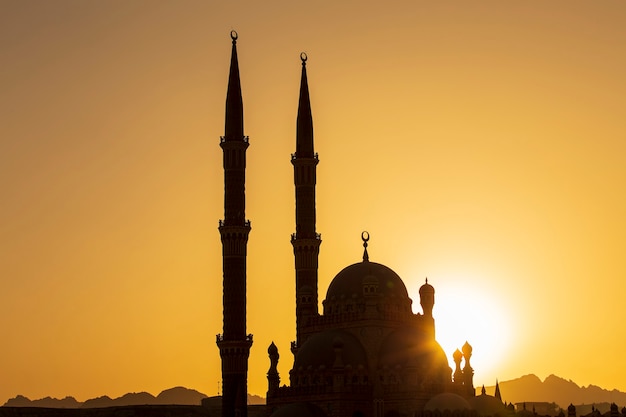 Silhouette Al-Sahaba Mosque at sunset time in Sharm el Sheikh, Egypt. Architecture of Al Sahaba, Al Mustafa, mosque in center of old town includes fusion of Fatimid, Mamluk and Ottoman style elements