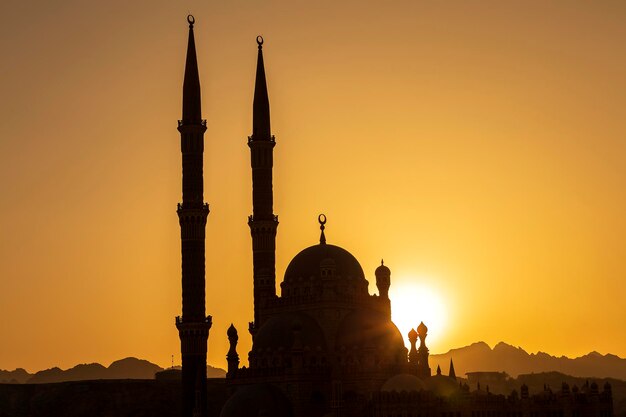 Silhouette AlSahaba Mosque at sunset time in Sharm el Sheikh Egypt Architecture of Al Sahaba Al Mustafa mosque in center of old town includes fusion of Fatimid Mamluk and Ottoman style elements