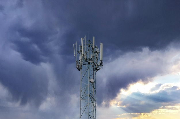 Silhouette Antenna tower and repeater of Communication and telecommunication with the mountain on the background of sunset.