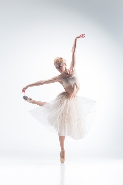 The silhouette of ballerina dancing on white background