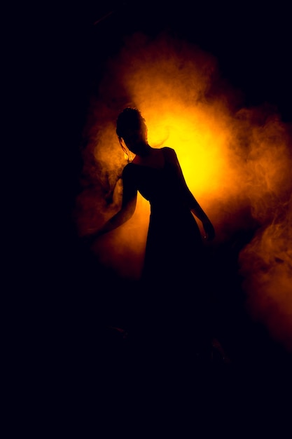 Silhouette of a beautiful girl in the fire flame