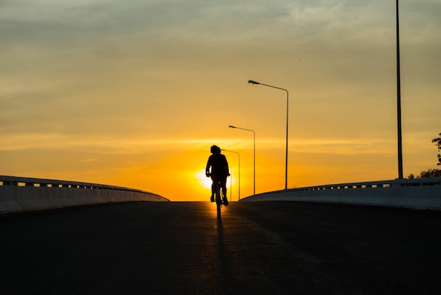 Silhouette of a bike on sky background on sunset