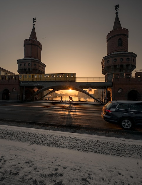 Silhouette bridge against clear sky in city during sunset