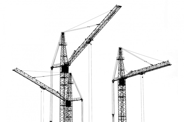 Silhouette of cranes at a construction site