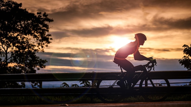 Silhouette of a cyclist Cyclist riding bicycle on a mountain at sunrise Doi Suthep Chiang mai