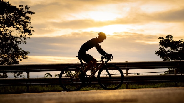 Silhouette of a cyclist Cyclist riding bicycle on a mountain at sunrise Doi Suthep Chiang mai