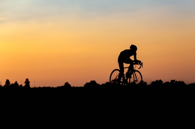 Silhouette of cyclist in motion on the background of beautiful sunset