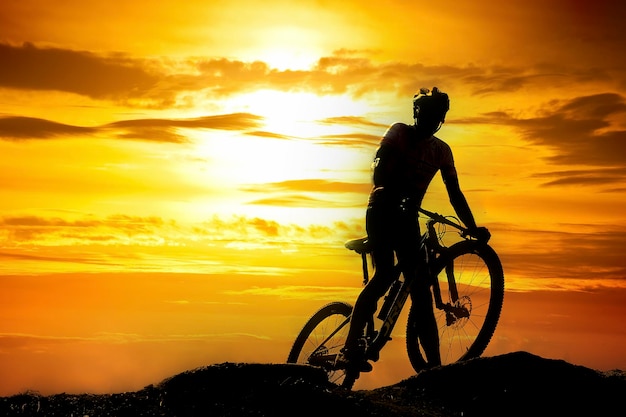 A silhouette of a cyclist practicing a bike ride on a mountain