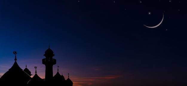 Silhouette dome mosques and crescent moon on dusk sky religion of Islamic in Ramadan month