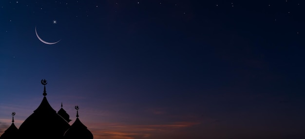 Silhouette dome mosques and crescent moon on dusk sky twilight background religion of Islamic