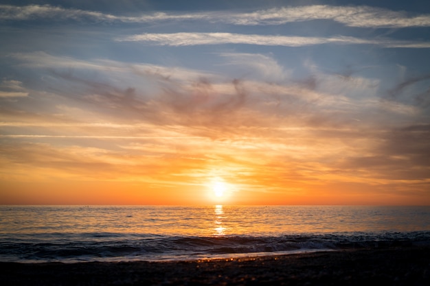 Silhouette of empty beach at sun set