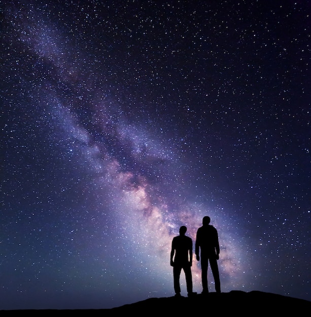 Silhouette of a father and son at night