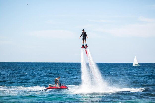 Silhouette of a fly board rider at sea