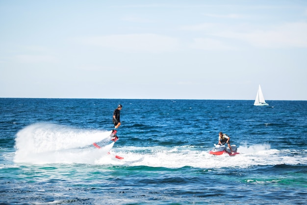 Silhouette of a fly board rider at sea