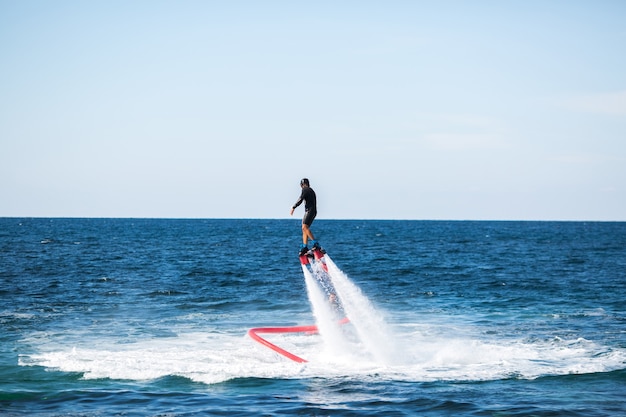 Silhouette of a fly board rider at sea