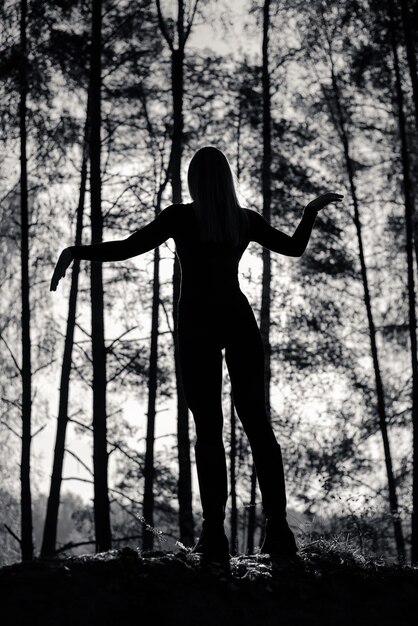 Silhouette of a Girl with a beautiful body in the Forest