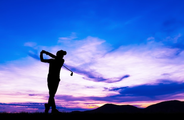 silhouette golfer playing golf during beautiful sunset