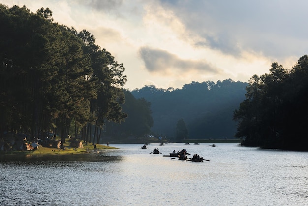 Silhouette group of tourists are rafting in morning sunlight at reservoir Pang Ung landmark mea hong son province Thailand