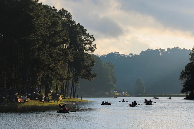 Silhouette group of tourists are rafting in morning sunlight at reservoir Pang Ung landmark mea hong son province Thailand