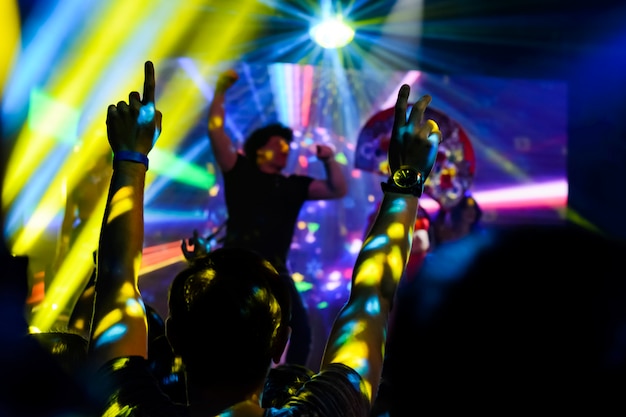 Silhouette of hands up at the concert