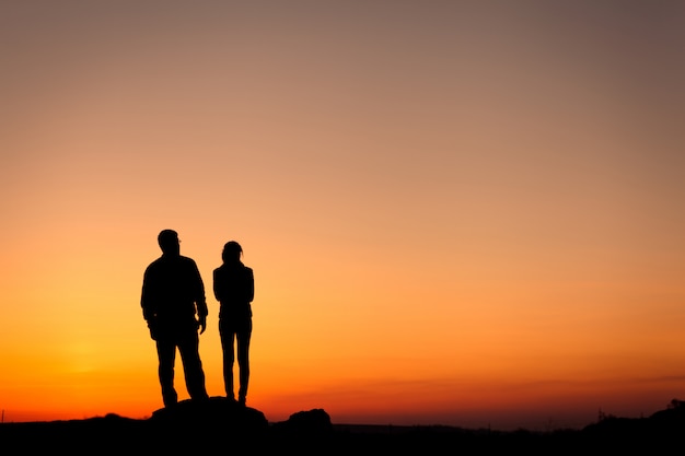 Silhouette of happiness family against beautiful colorful sky. S