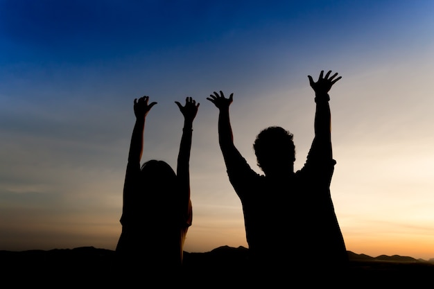 Silhouette happy couple with twilight sky background