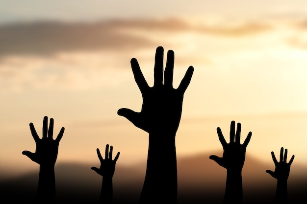 Silhouette Human hands open palm up worship background