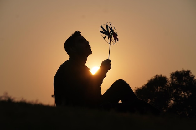 Silhouette image A boy with handmade toy in morning with son